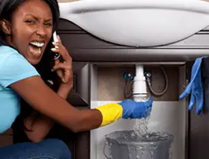 Emergency plumbing repair for a leaking sink drain under a bathroom vanity in Anaheim, CA