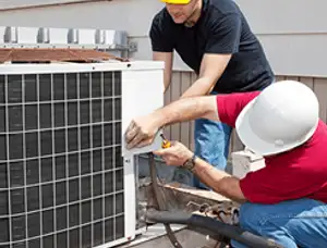 HVAC technicians repairing an outdoor AC unit on a rooftop in Anaheim, CA