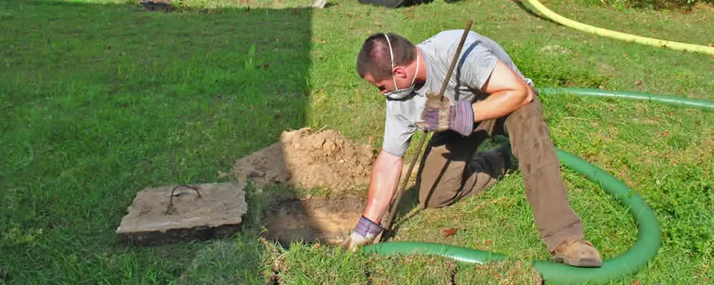Septic pumping technician servicing a residential septic tank in Anaheim, CA
